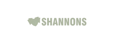 The logo of Shannons, featuring the word 'Shannons' in a light green, vintage serif font, accompanied by a stylized heart shape above the letter 'n' on a transparent background.